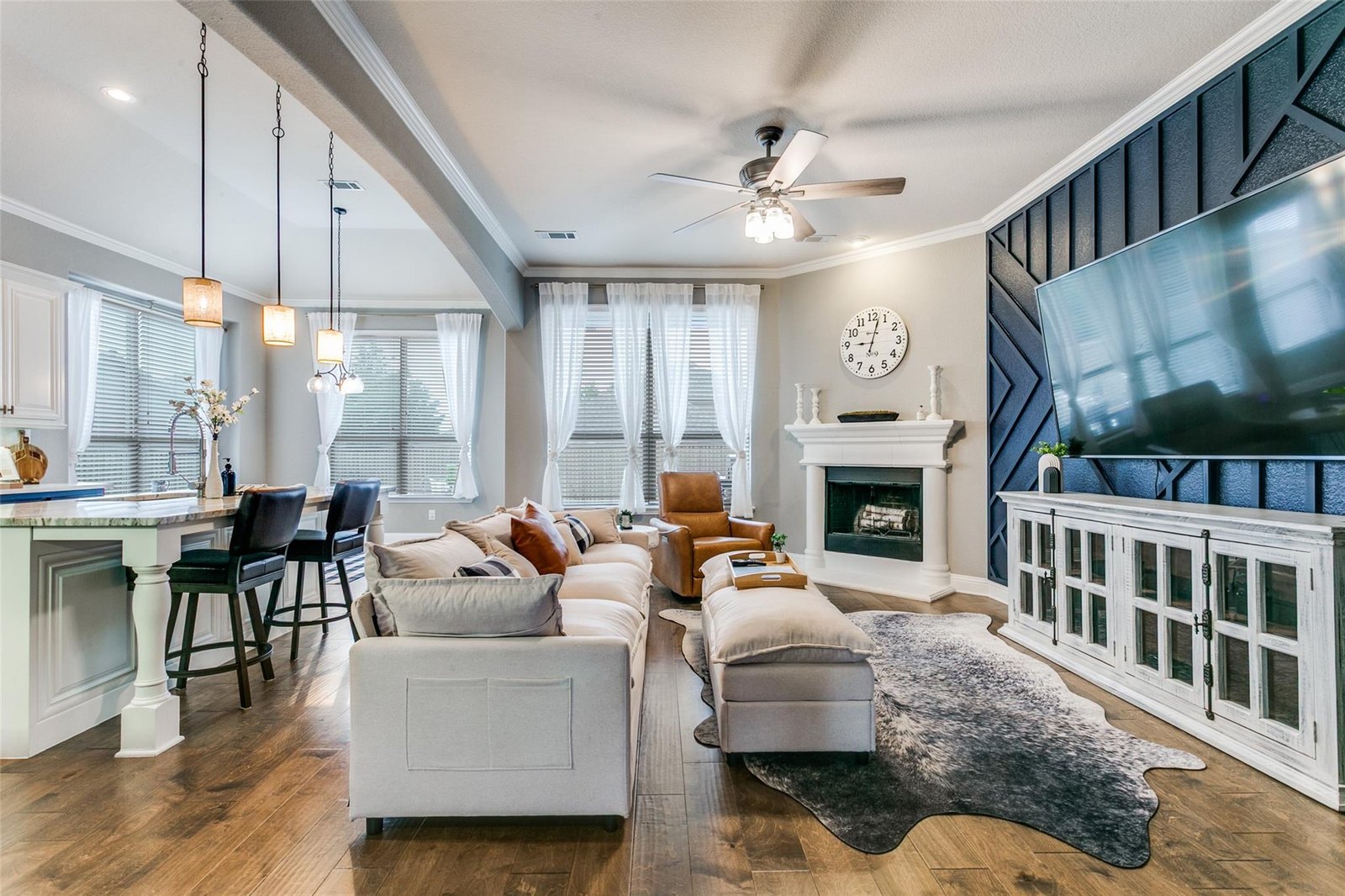Open-concept living room with stone fireplace at 104 Martingale Trl, Oak Point