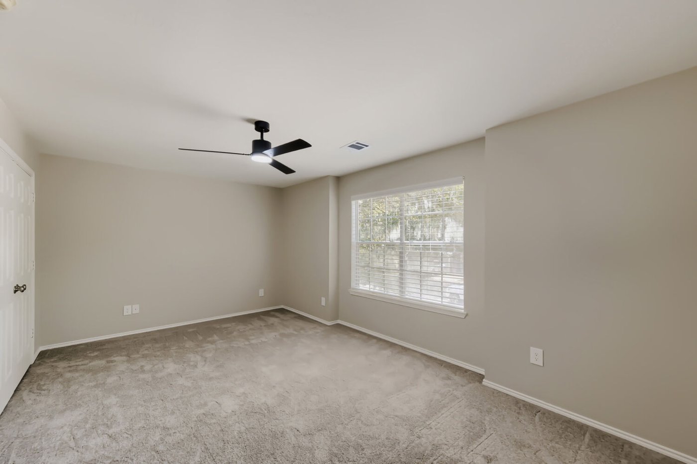Second bedroom with a window and modern ceiling fan at 11 Wineberry Pl