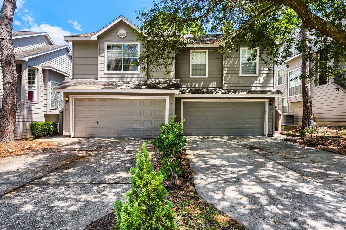 Front exterior of 11 Wineberry Pl, a brick and siding townhome for lease in The Woodlands, TX