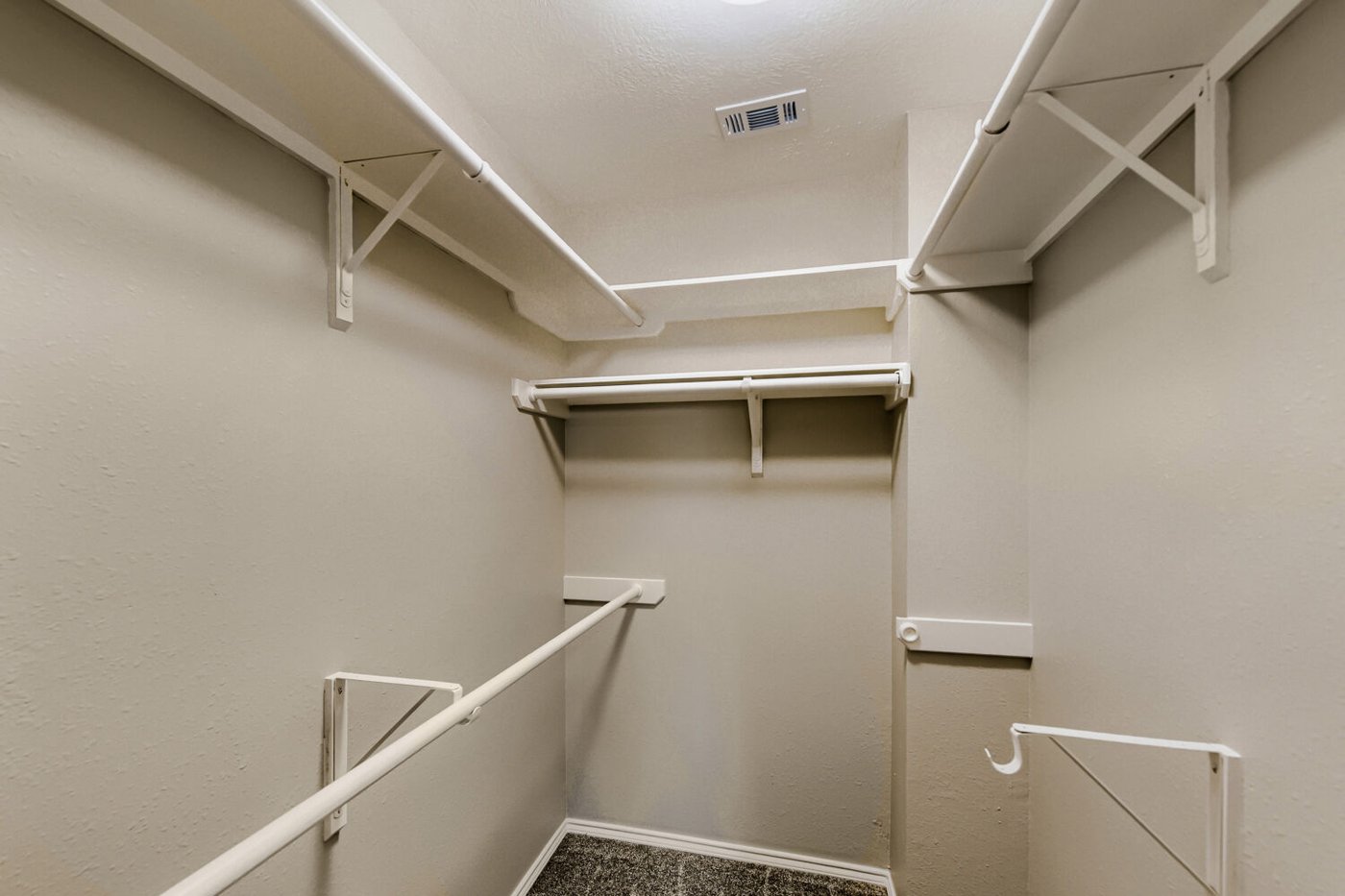 Primary walk in closet with custom built in shelving at 11 Wineberry Pl