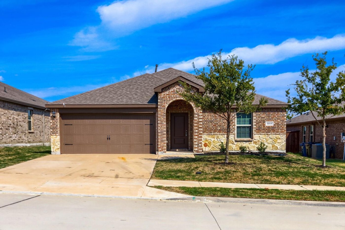 Front exterior of 1212 Rountree Ct, a one-story brick home for sale in the Chalk Hill community of Celina, TX