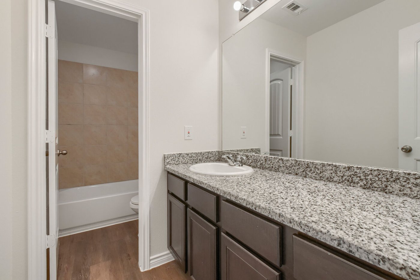Second full bathroom with granite vanity at 1309 Fantail Ln, Ennis, TX