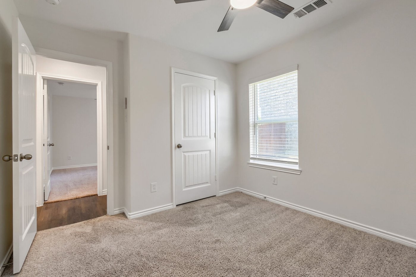 Second bedroom with carpet and ceiling fan at 1309 Fantail Ln, Ennis