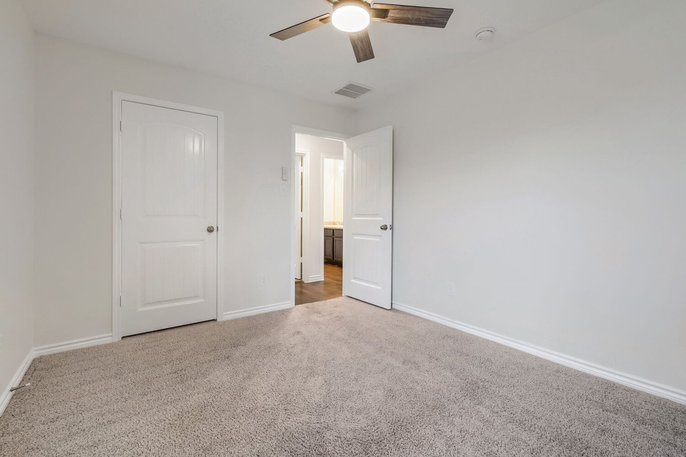 Bedroom with closet and laminate wood flooring at 1309 Fantail Ln, Ennis