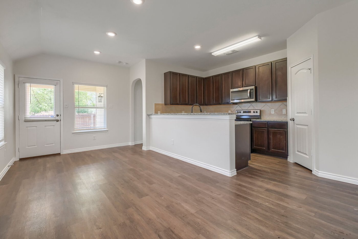 Dining area with laminate wood flooring at 1309 Fantail Ln, Ennis, TX