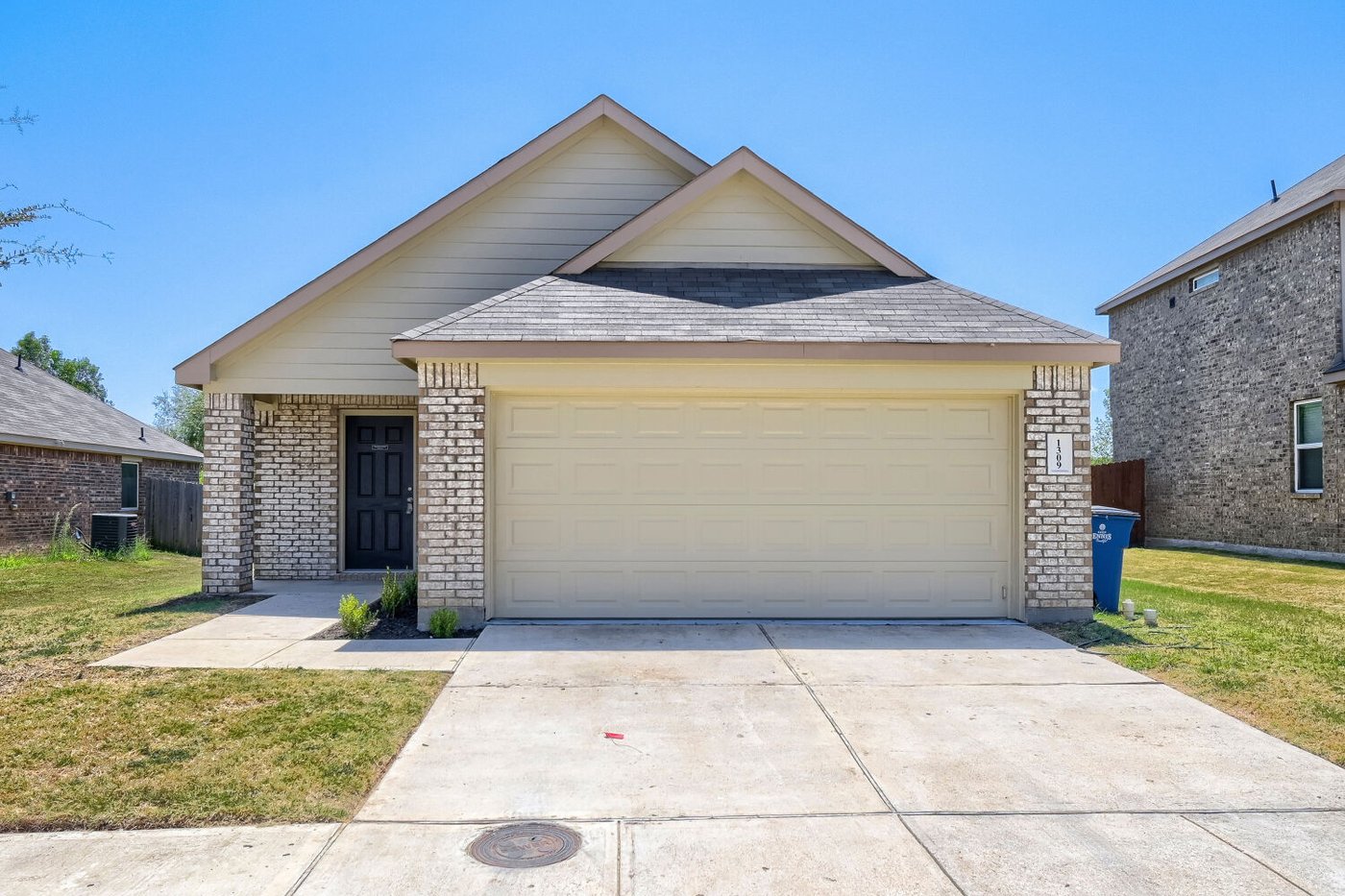 Angled front view of 1309 Fantail Ln with a two car garage in Ennis, TX