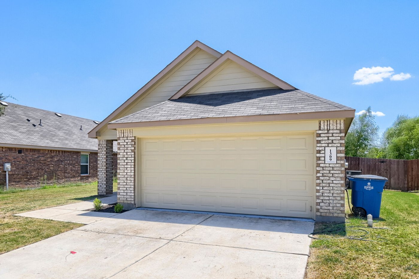 Curb view of the brick front elevation at 1309 Fantail Ln, Ennis