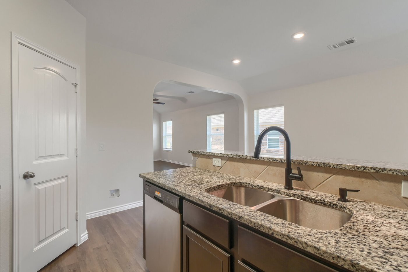 Kitchen sink and stainless steel range at 1309 Fantail Ln, Ennis, TX