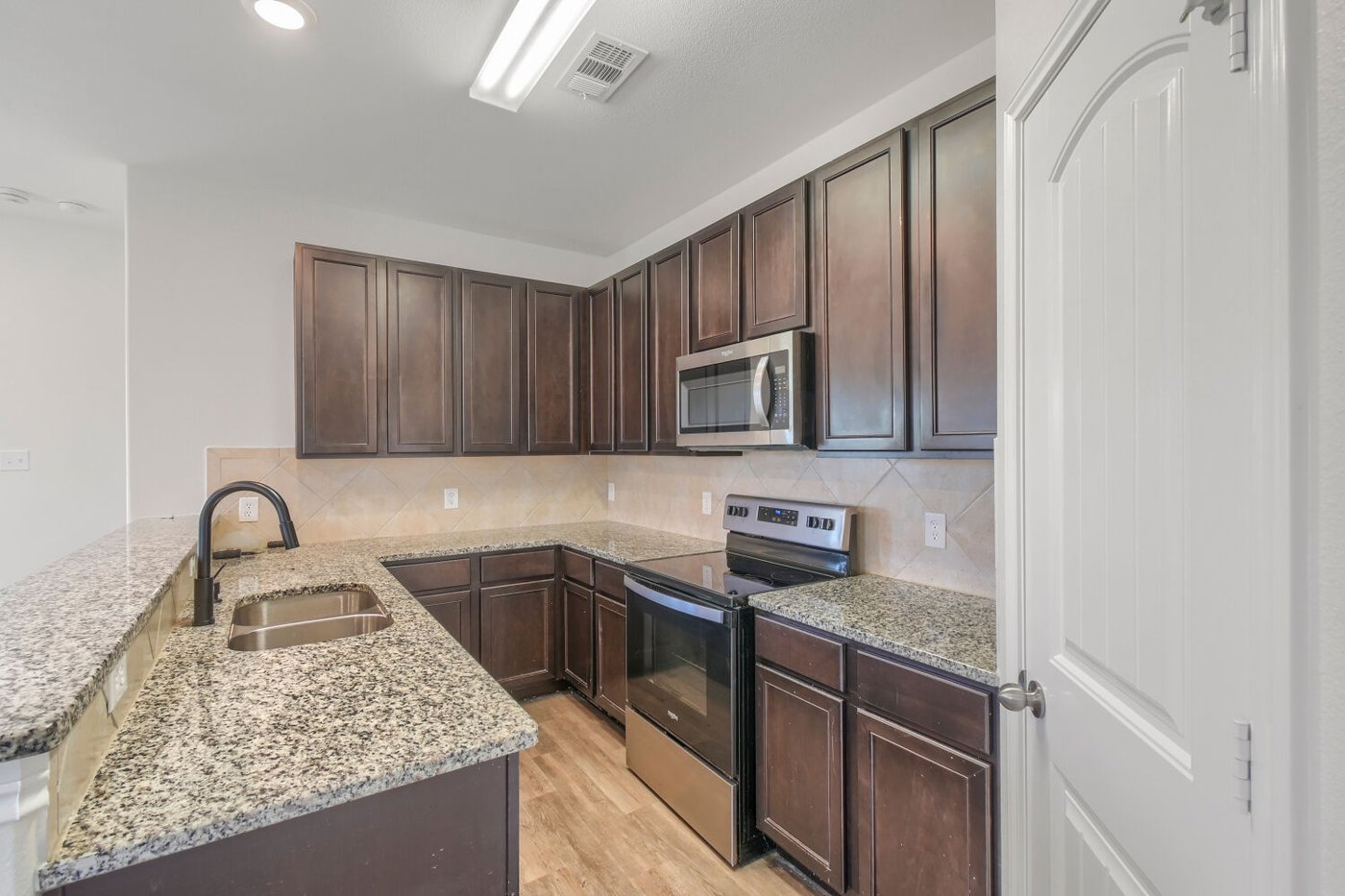 Kitchen with granite countertops and stainless steel appliances at 1309 Fantail Ln