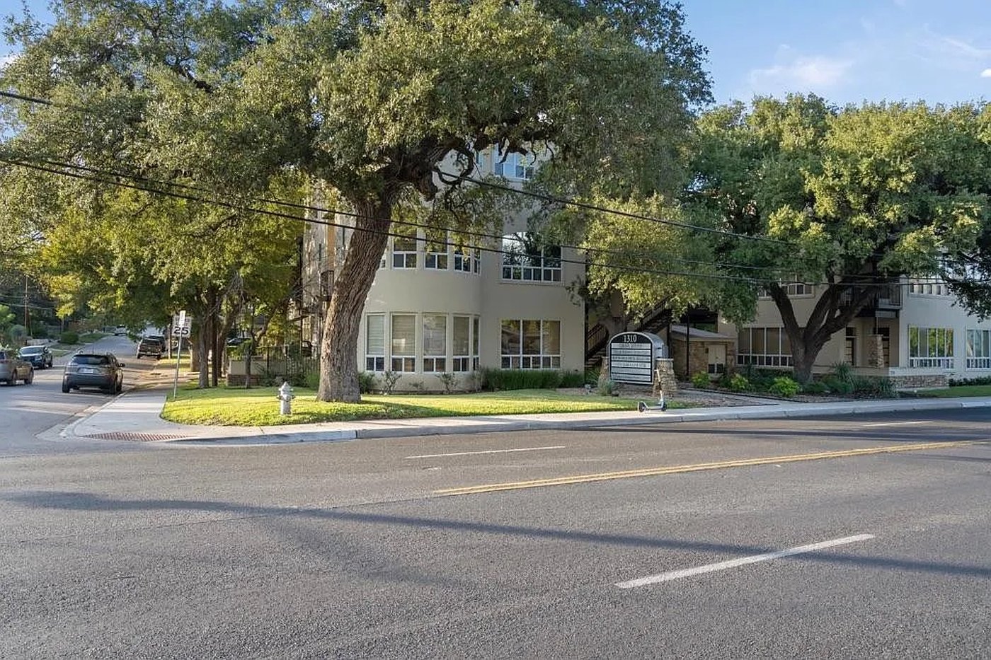 Exterior of 1310 S 1st St #310, a third floor condo nestled among oak trees in Austin, Texas