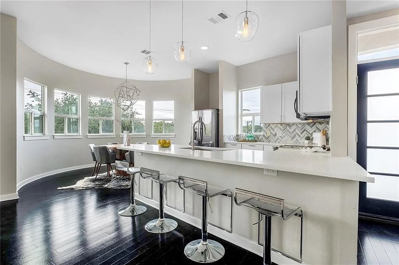 Open kitchen and dining rotunda with curved windows at 1310 S 1st St #310 Austin condo for lease