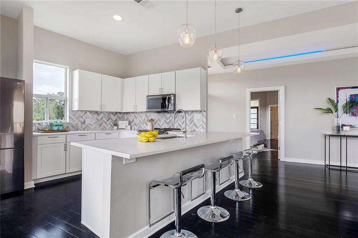 Chef kitchen with center island, stainless steel appliances and bar seating at 1310 S 1st St #310