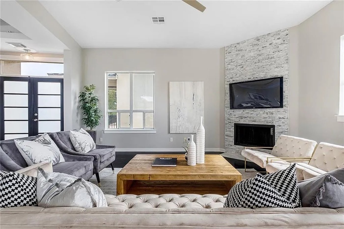 Open living room with a modern fireplace and bamboo flooring at 1310 S 1st St #310 in Austin