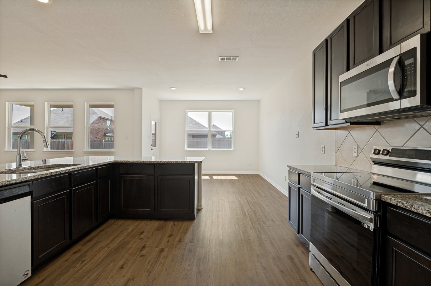 Kitchen with granite counters and a stainless steel range at 1403 Kinglet Dr, Ennis