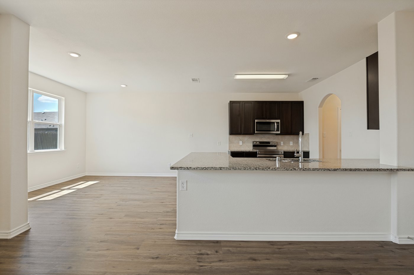 Kitchen with granite countertops and a breakfast bar at 1403 Kinglet Dr, Ennis, TX