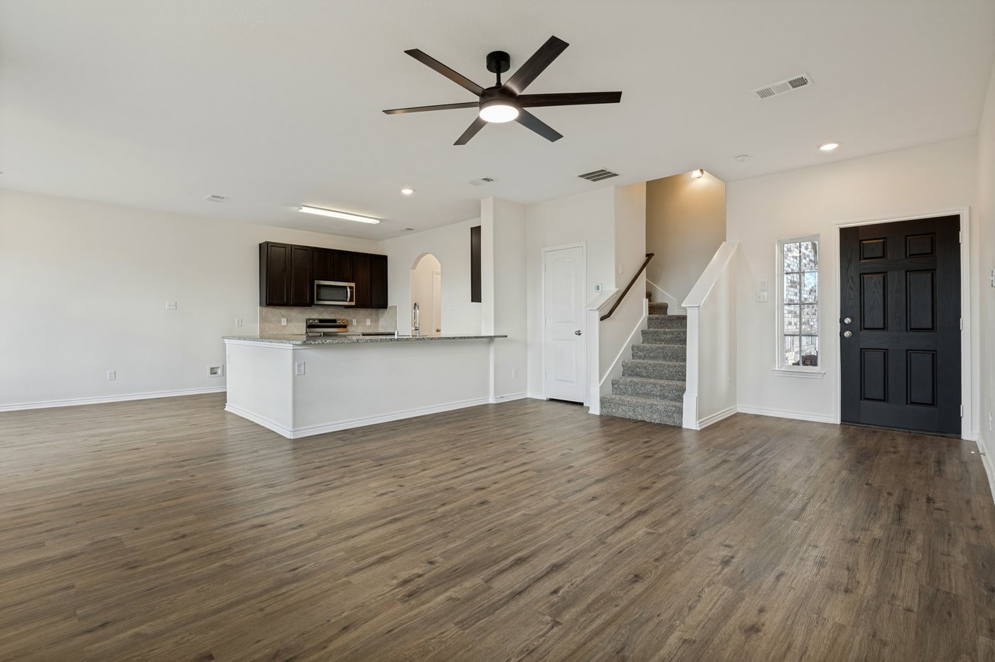 Open living area looking toward the kitchen at 1403 Kinglet Dr, Ennis