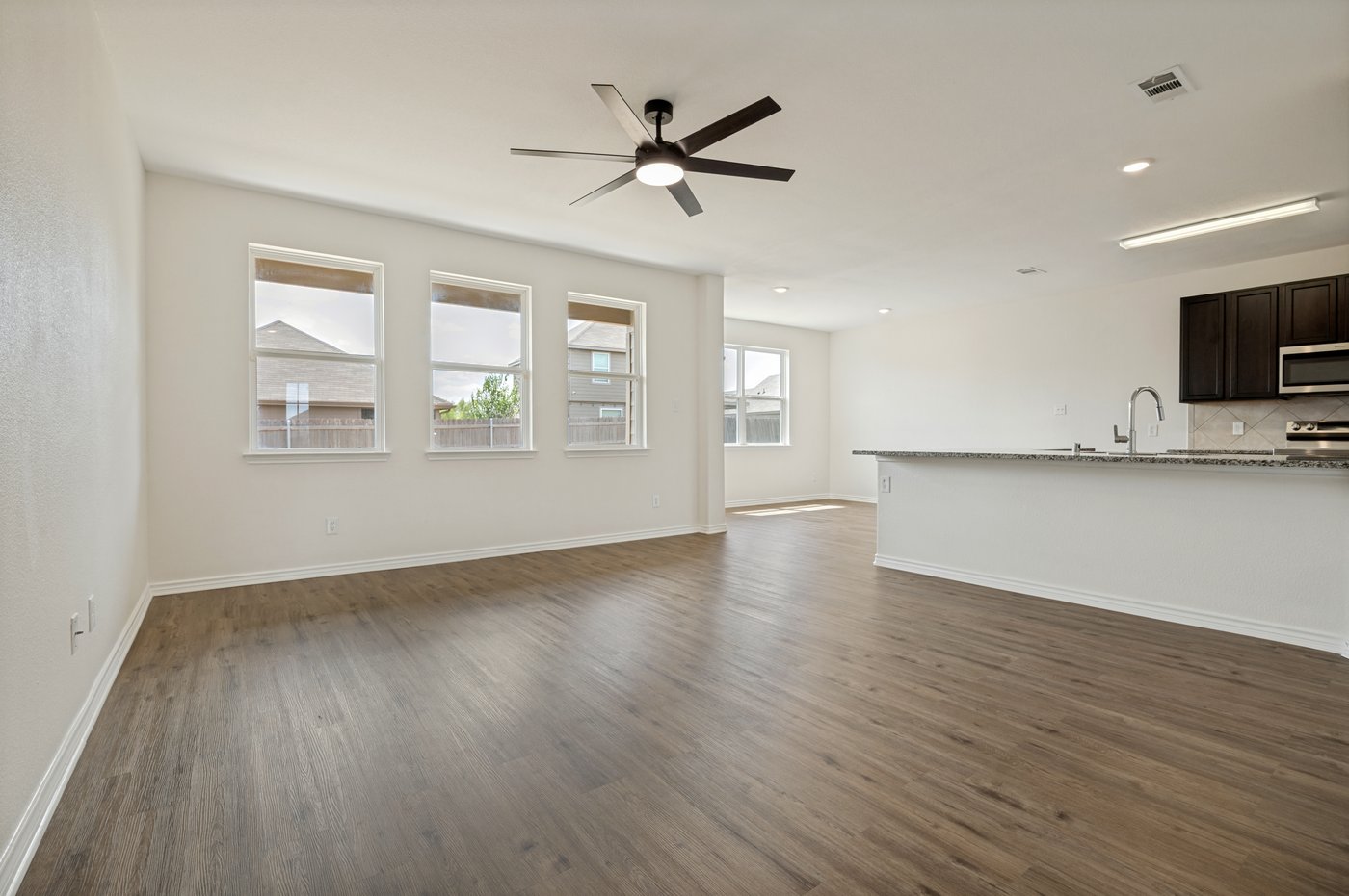 Bright living room with large windows at 1403 Kinglet Dr, Ennis, TX