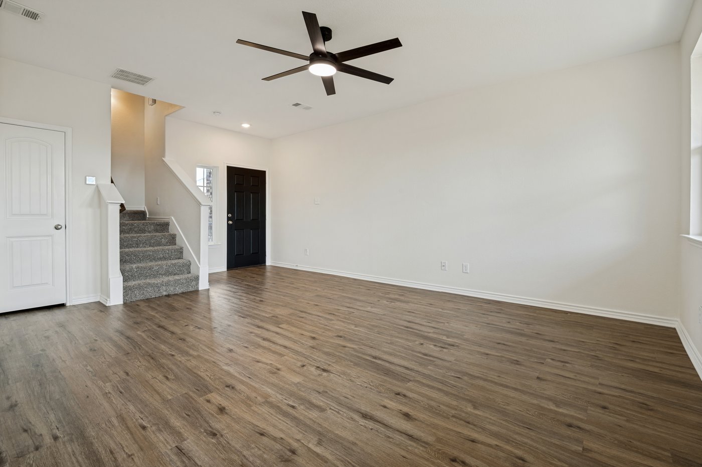 Living room with new laminate wood look flooring at 1403 Kinglet Dr, Ennis, TX