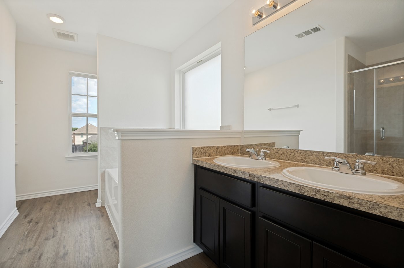 Primary bathroom with dual vanities at 1403 Kinglet Dr, Ennis