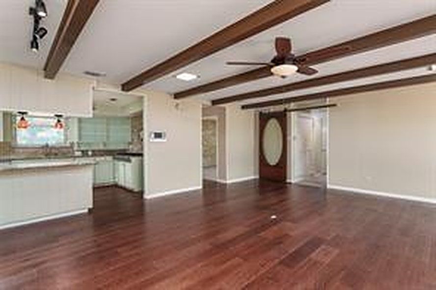 Living room with wood beams and wood flooring at 1608 Freeman Ct, Arlington