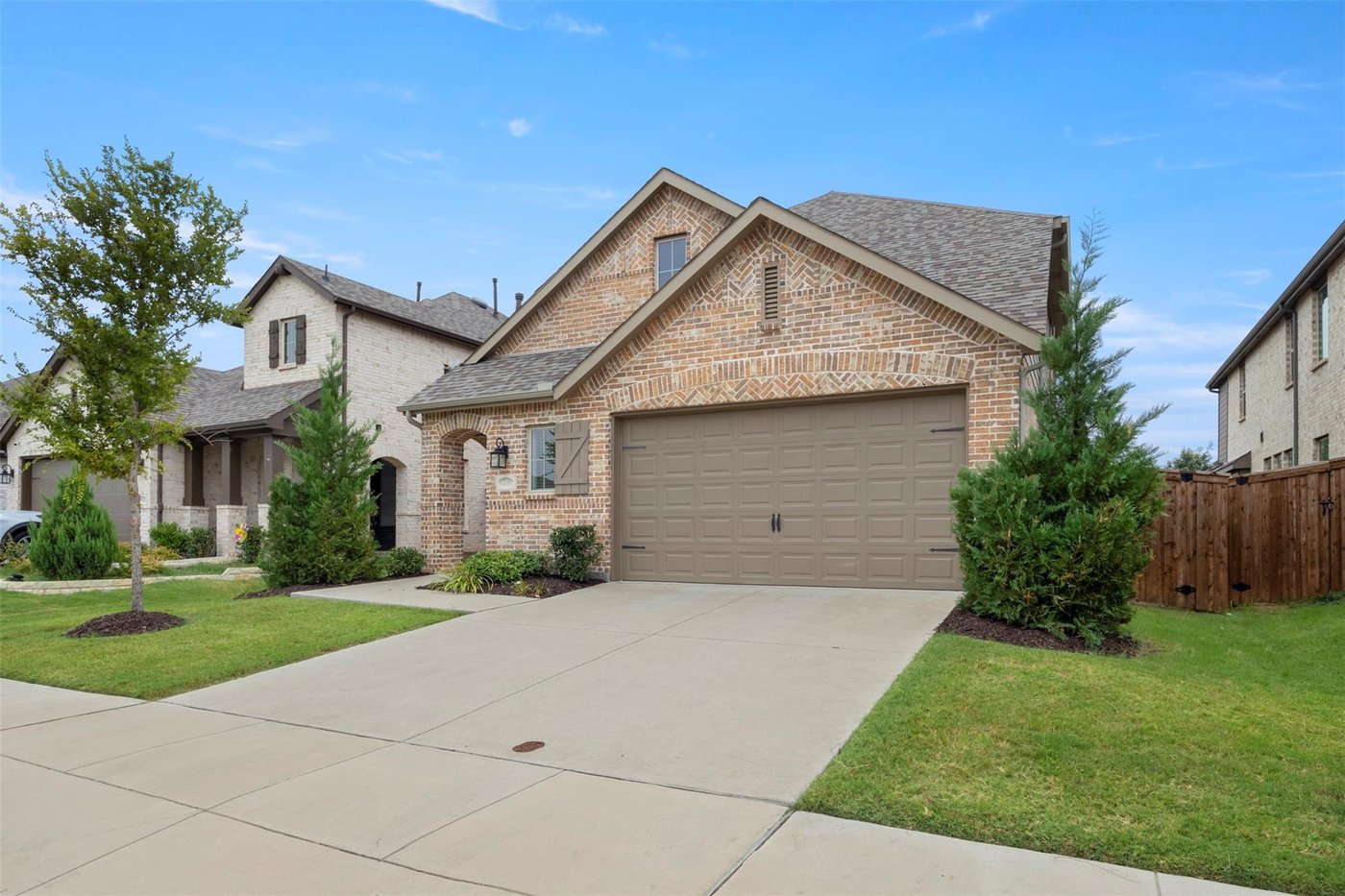 Angled front view of 1848 Coronet Ave with a two car garage in Aubrey, TX