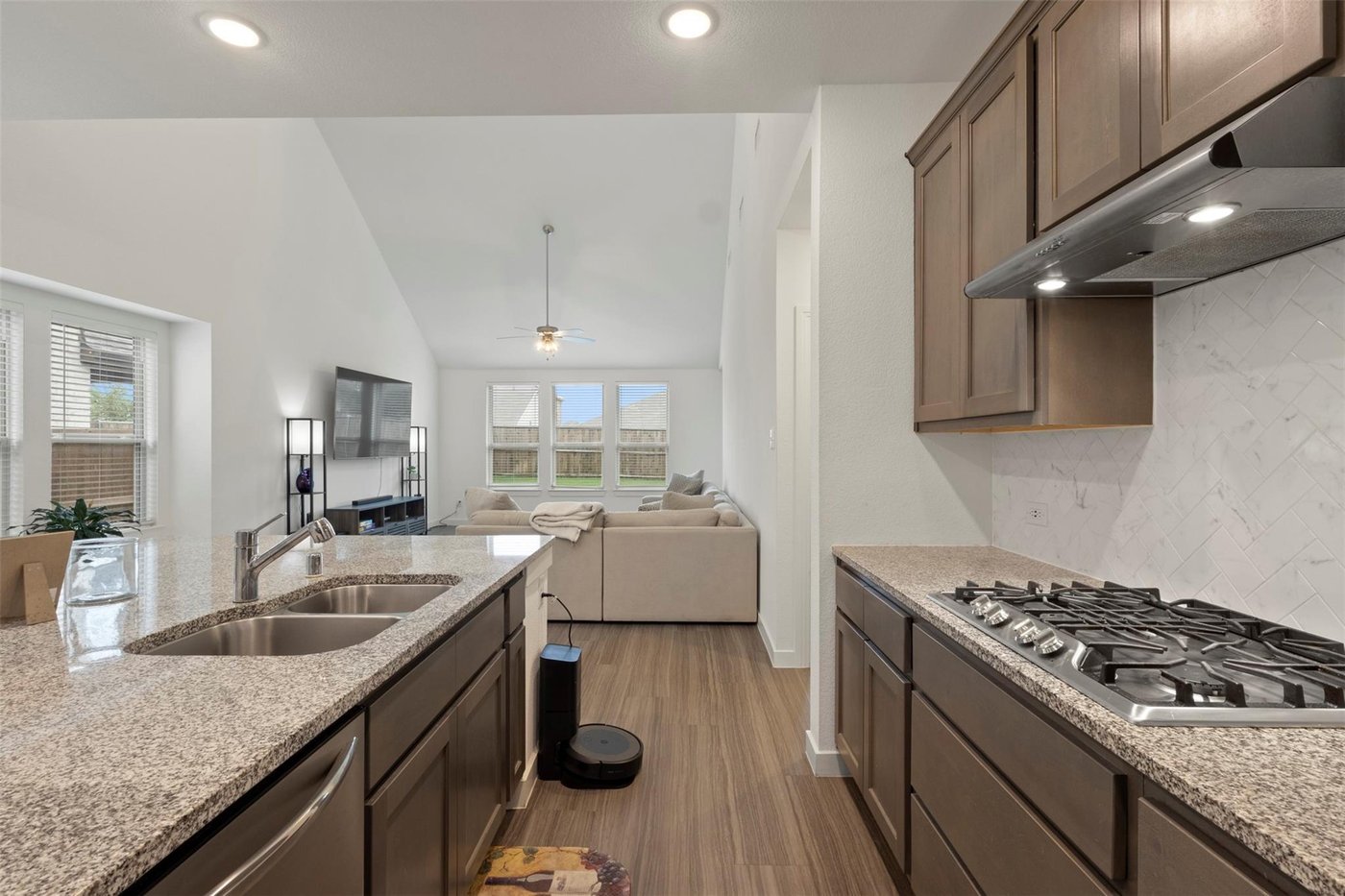Kitchen island with seating and stainless steel appliances at 1848 Coronet Ave, Aubrey