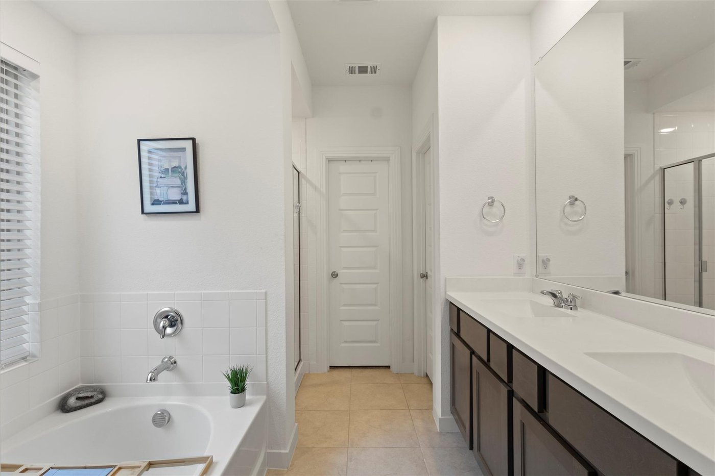 Spa-like primary bath with a soaking tub and dual vanities at 1848 Coronet Ave, Aubrey