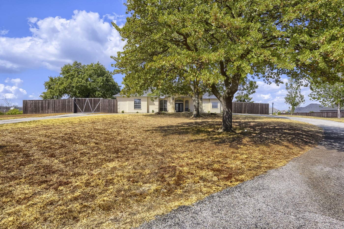 Front exterior of 201 N Garza Rd, an updated home on over 1.5 acres for sale in Shady Shores, TX