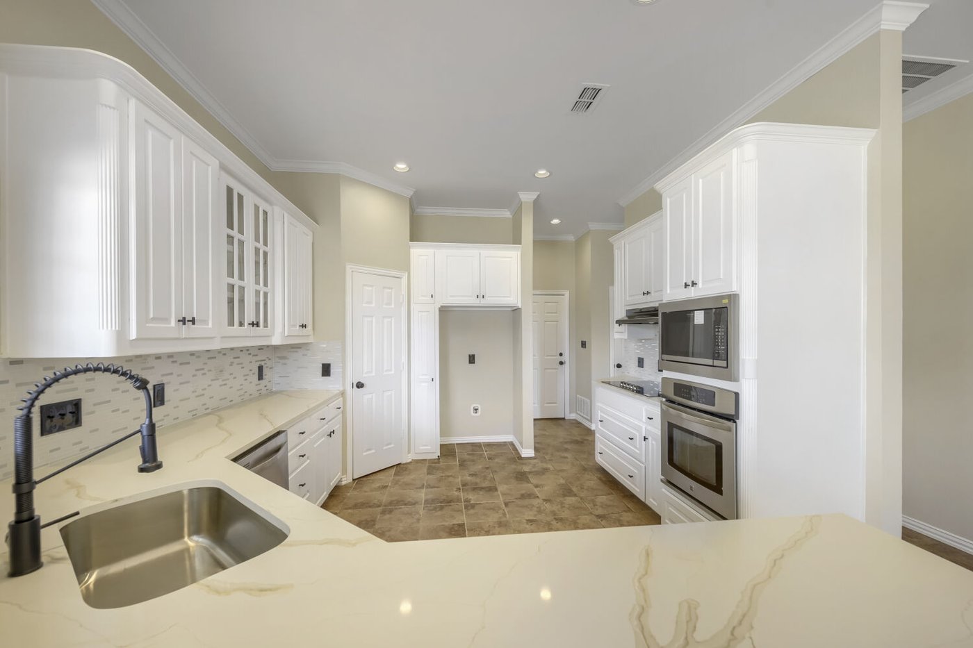 Stainless steel appliances and ample cabinetry in the kitchen at 201 N Garza Rd, Shady Shores