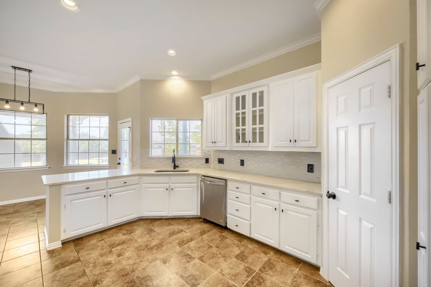 Updated kitchen with white cabinetry and stainless steel appliances at 201 N Garza Rd, Shady Shores