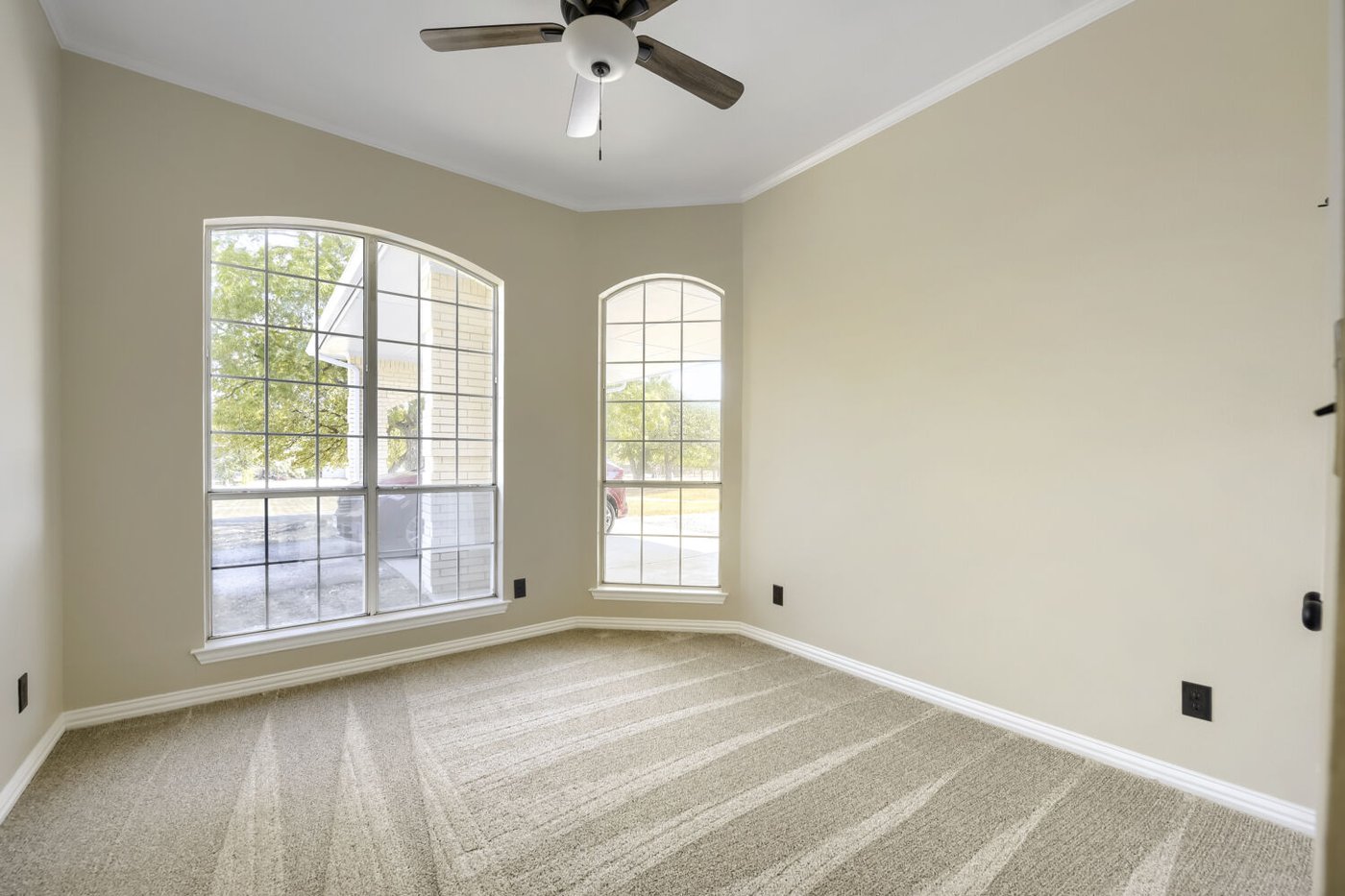 Primary suite with a tray ceiling at 201 N Garza Rd, Shady Shores, TX