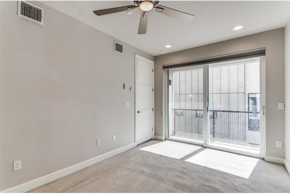 Bedroom with a ceiling fan and patio access at 2016 N Fitzhugh Ave #104, Dallas