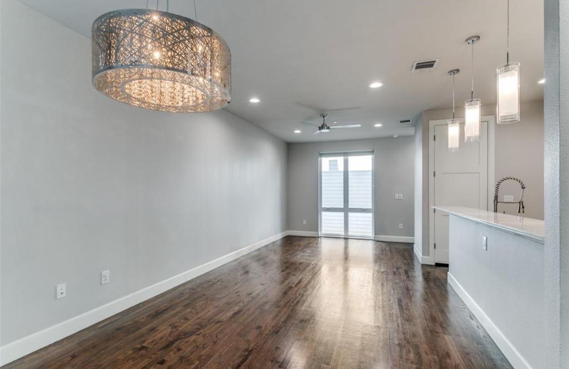 Bright open living and dining area with a modern chandelier at 2016 N Fitzhugh Ave #104, Dallas