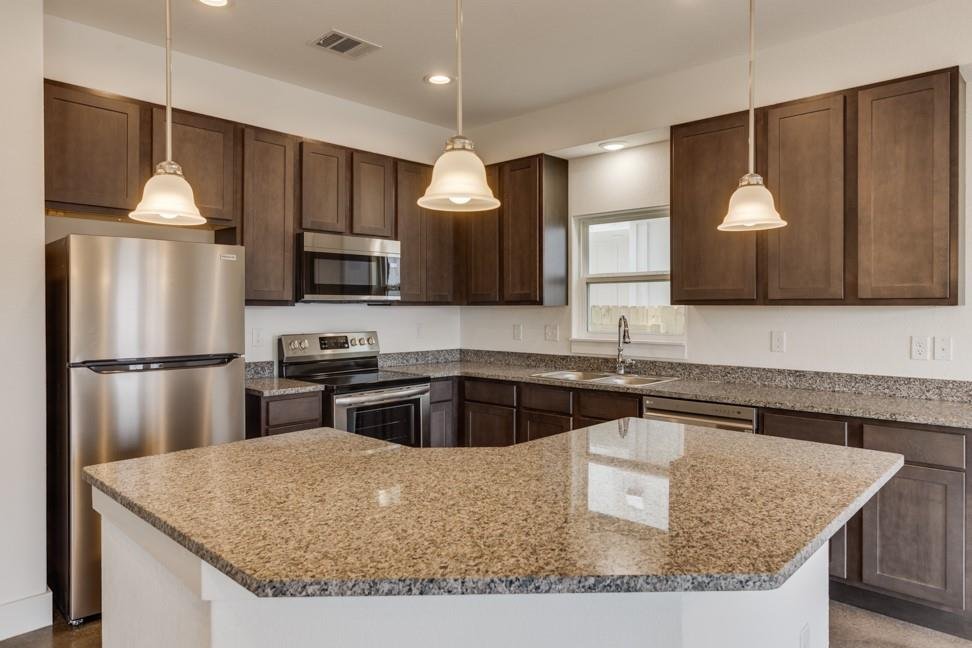 Kitchen island with granite counters at 206 Topaz, New Braunfels TX