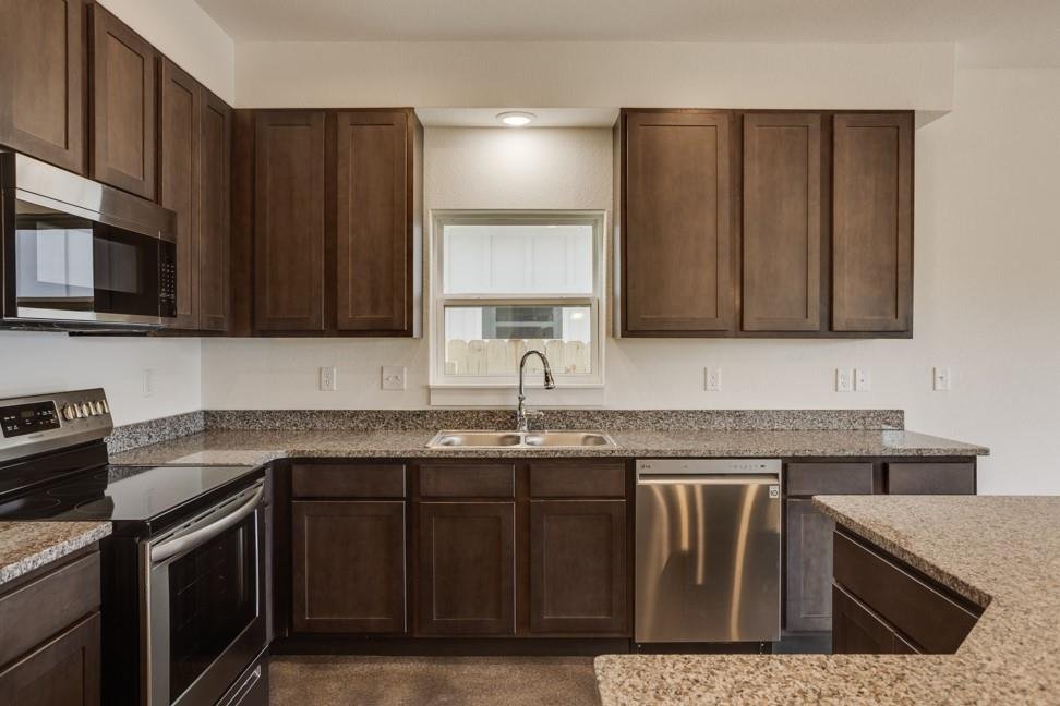 Kitchen with granite countertops and stainless steel appliances at 206 Topaz in New Braunfels