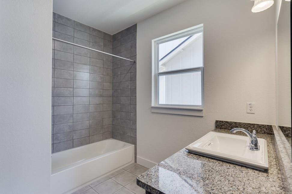 Primary bathroom with glass shower and granite vanity at 206 Topaz, New Braunfels TX