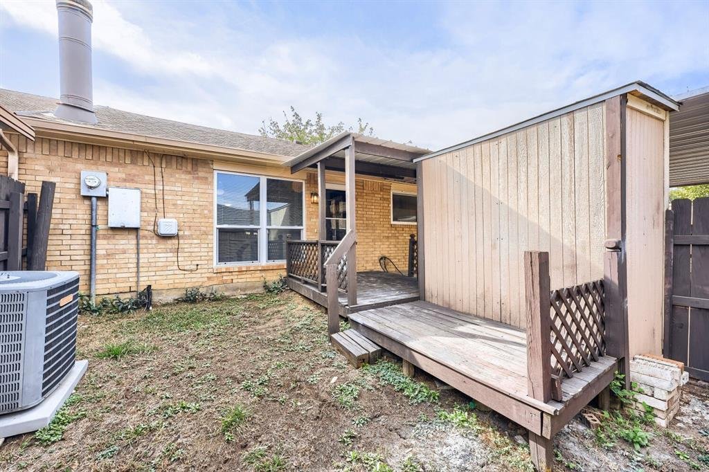 Private fenced backyard with a deck at 22 E Townhouse Ln #31, Grand Prairie