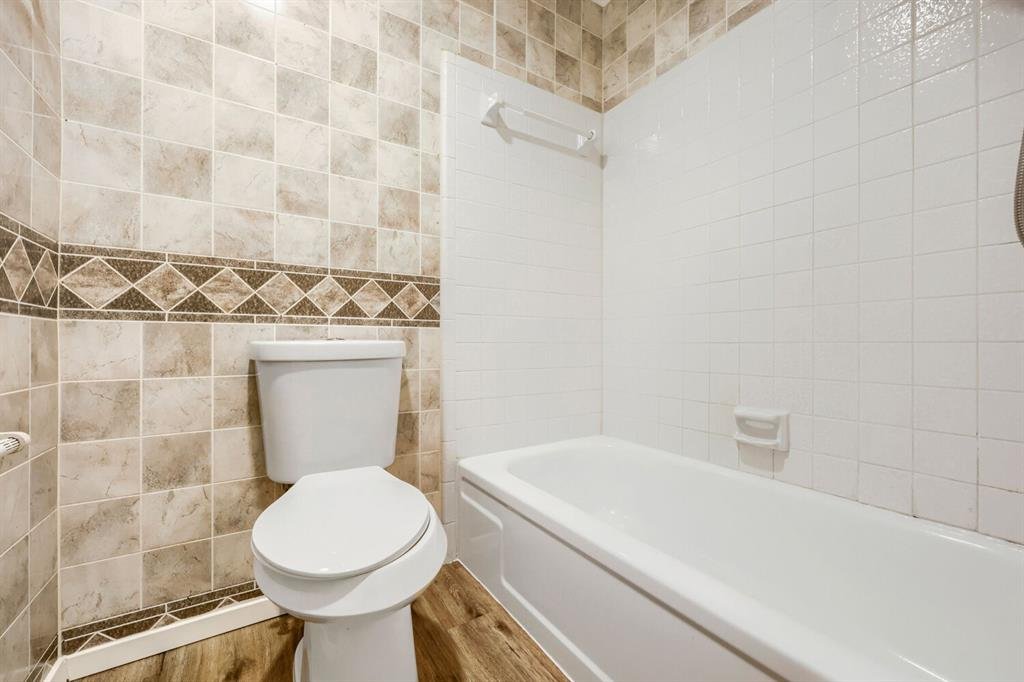Full bathroom with a tub and tile surround at 22 E Townhouse Ln #31, Grand Prairie
