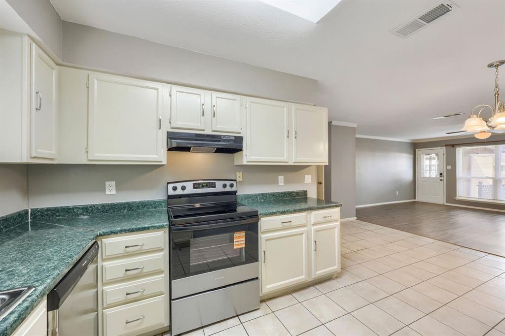 Kitchen opening to the dining and living areas at 22 E Townhouse Ln #31, Grand Prairie