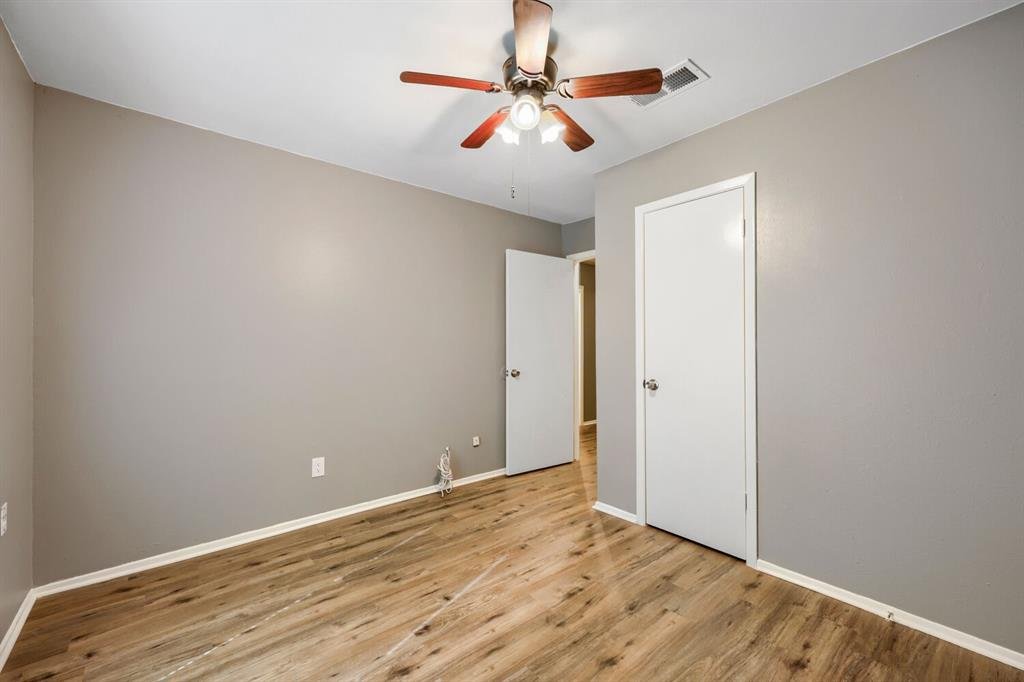 Primary bedroom with a ceiling fan and walk-in closet at 22 E Townhouse Ln #31, Grand Prairie