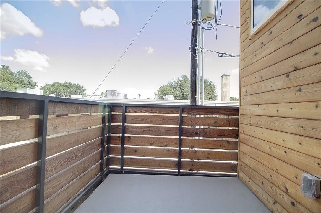 Private balcony with wood accents at 2310 N Carroll Ave Unit 105, Dallas