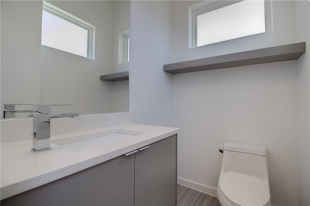 Powder bath with a quartz vanity at 2310 N Carroll Ave Unit 105, Dallas