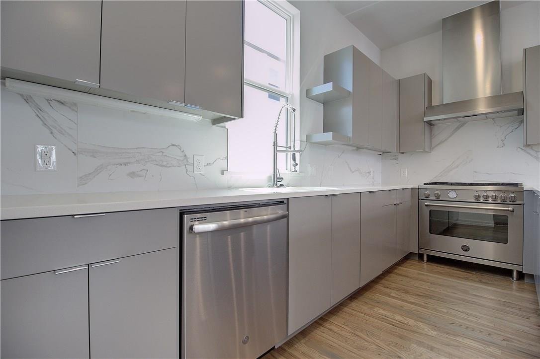 Quartz counters and stainless steel appliances in the kitchen at 2310 N Carroll Ave Unit 105