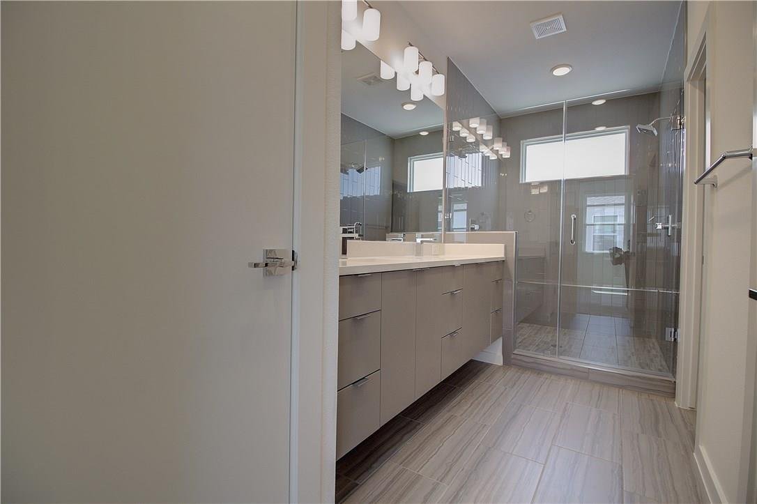 Master bath with double vanity and a glass shower at 2310 N Carroll Ave Unit 105