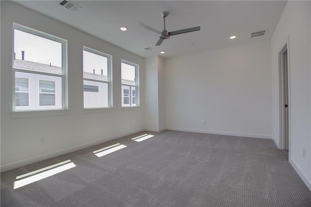 Primary bedroom with carpet and large windows at 2310 N Carroll Ave Unit 105