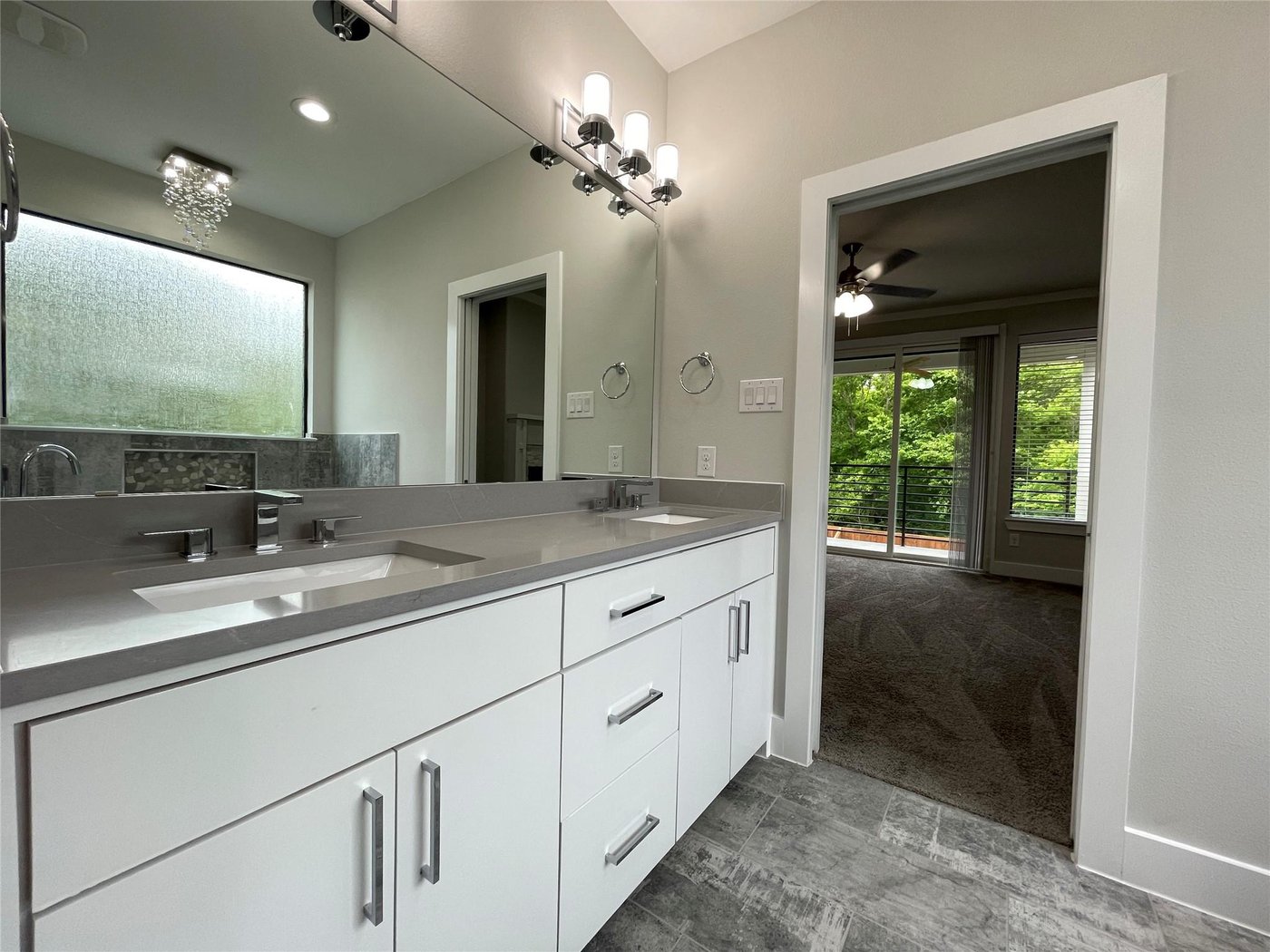 Full en suite bath with a dual sink vanity at 2417 N Winnetka Ave, Dallas
