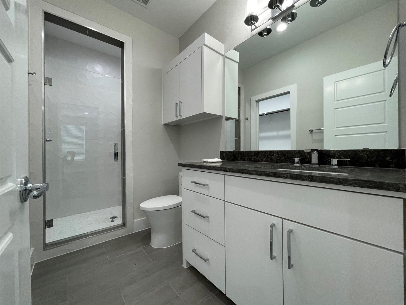 Full bathroom with a glass shower and vanity at 2417 N Winnetka Ave, Dallas