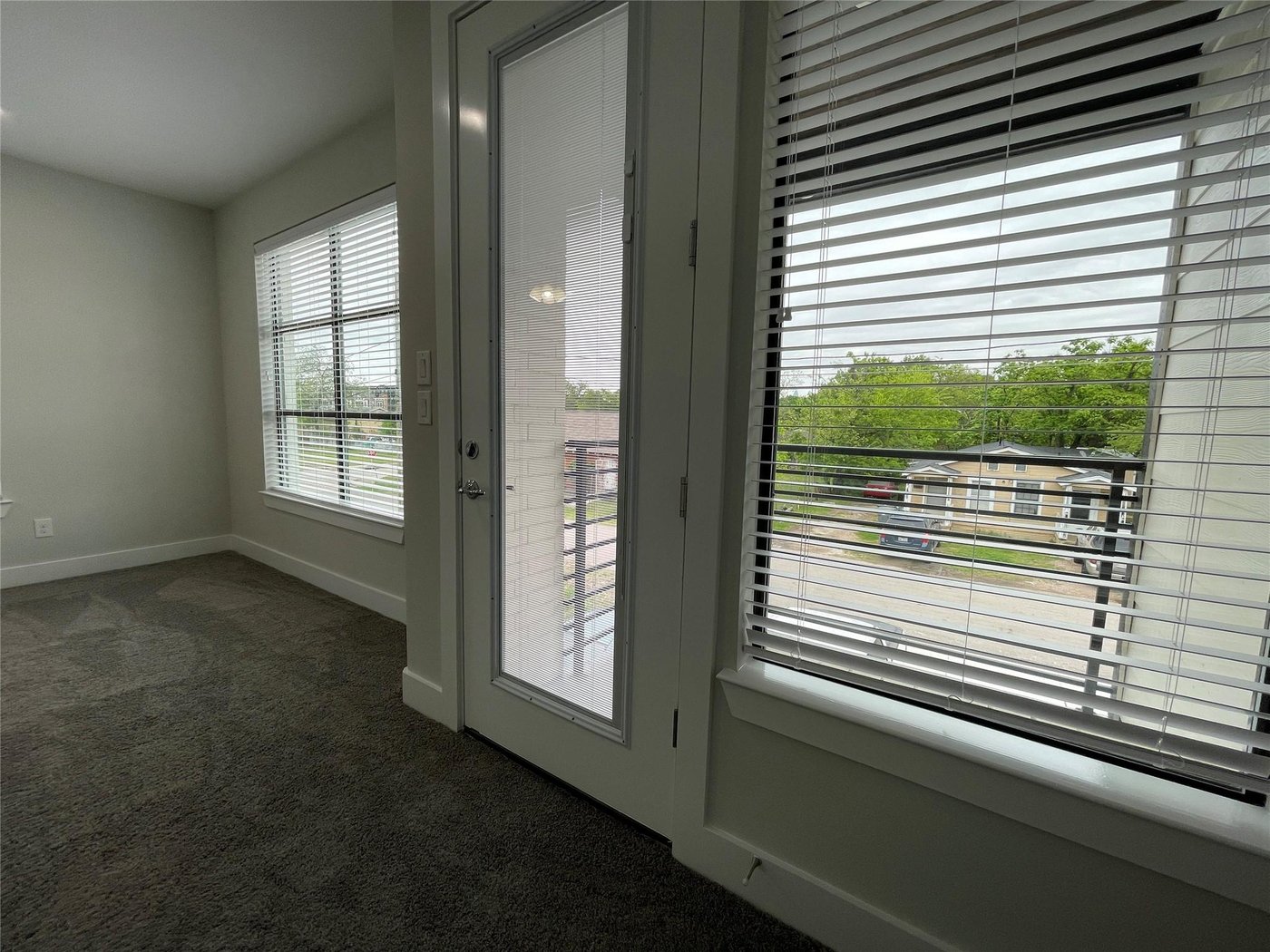 Second bedroom suite with a private balcony door at 2417 N Winnetka Ave, Dallas