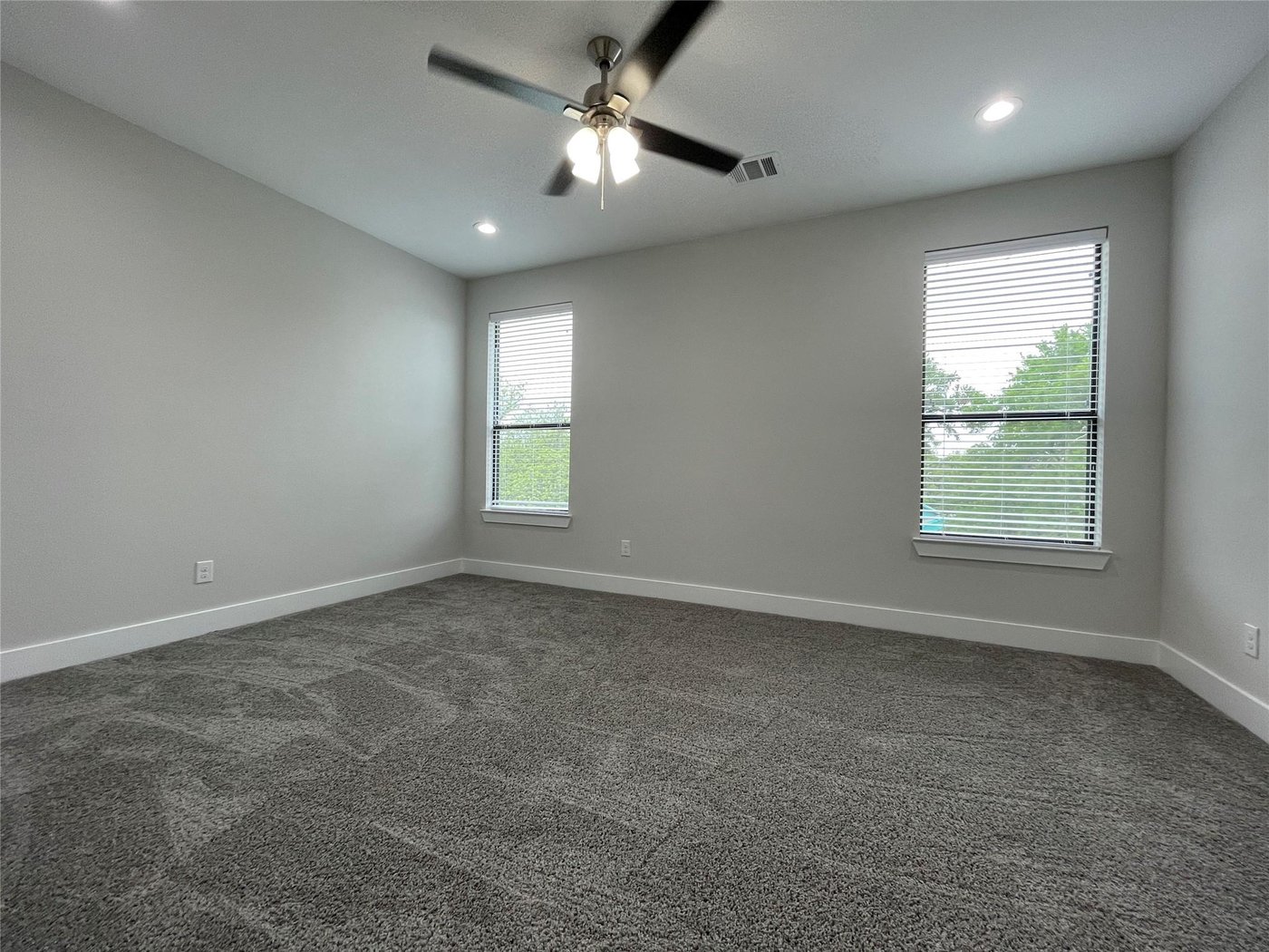 Third floor bedroom with carpet and natural light at 2417 N Winnetka Ave, Dallas