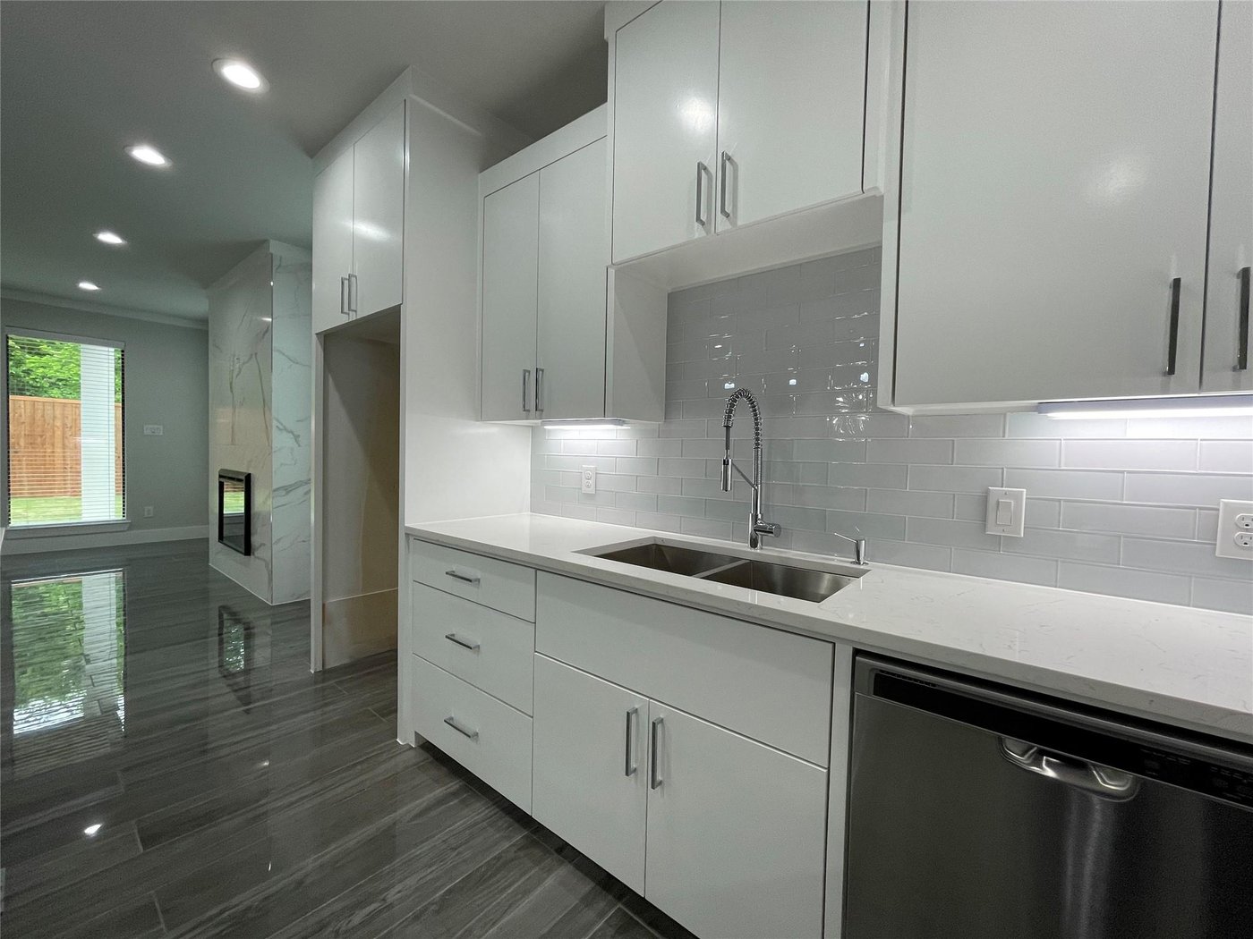 Kitchen with white cabinetry and stainless steel sink at 2417 N Winnetka Ave